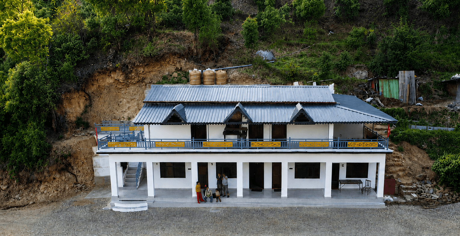 Front exterior of Himgiri Home Stay surrounded by hillside greenery