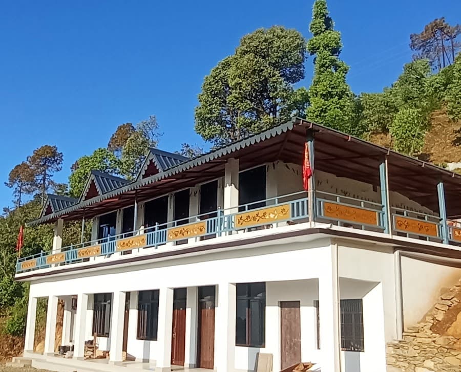 Himgiri Home Stay exterior with mountain-style balcony